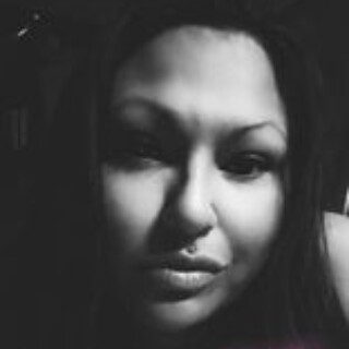 Headshot of poet Stephanie "Sage" Giroux, an indigenous woman with long dark hair and dark eyes.